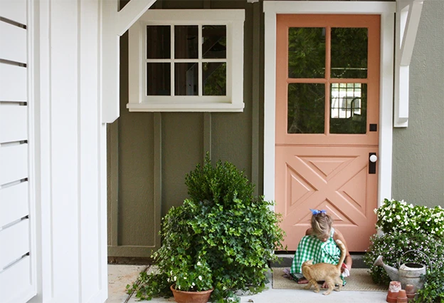 Painted Dutch door on the exterior of a cottage style home