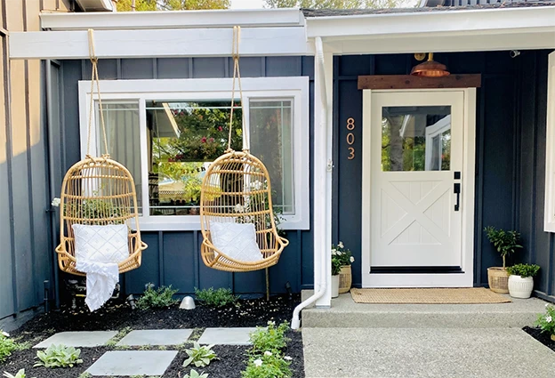White cross buck door on the entry of a cottage style home