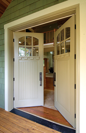 Entrance with wood double doors and dentil shelf