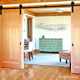 Den with interior barn doors