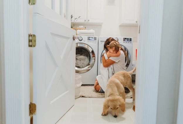 White painted Dutch door in the entry of a laundry room.