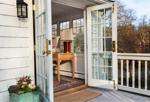 White painted French doors with SDL bars open on the back patio